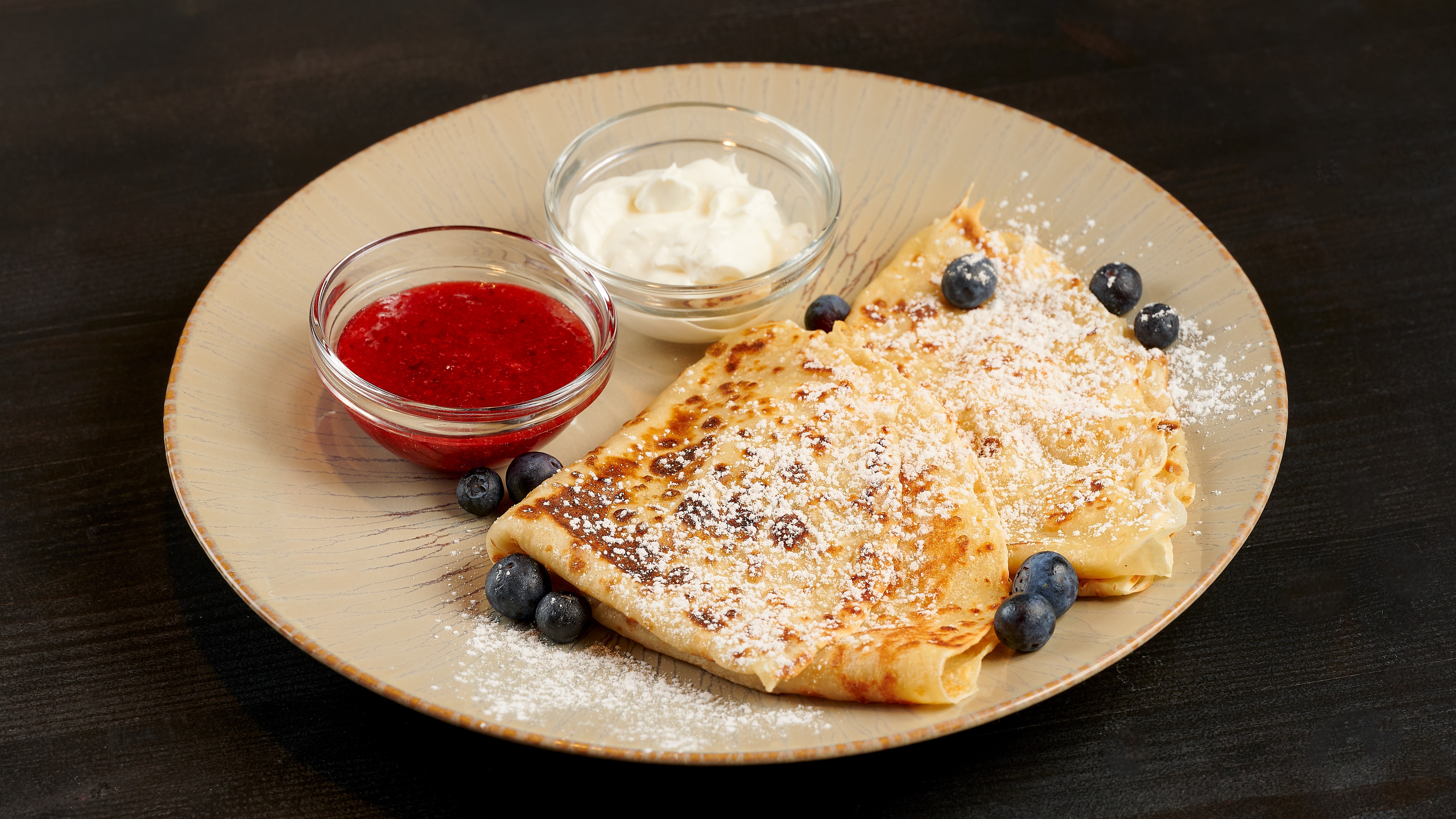 Homemade pancakes with berries and cream