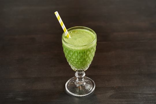 Green smoothie with paper straw